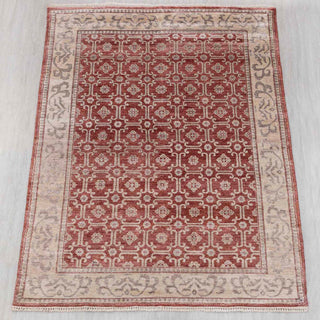 Wool hand-knotted rug in terracotta red and beige with geometric lattice design, 6x9.